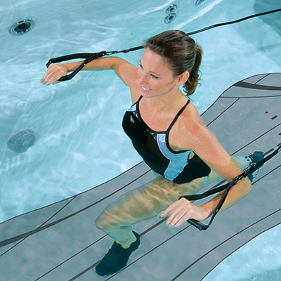 Elderly lady doing aerobics in and H2X Swim Spa